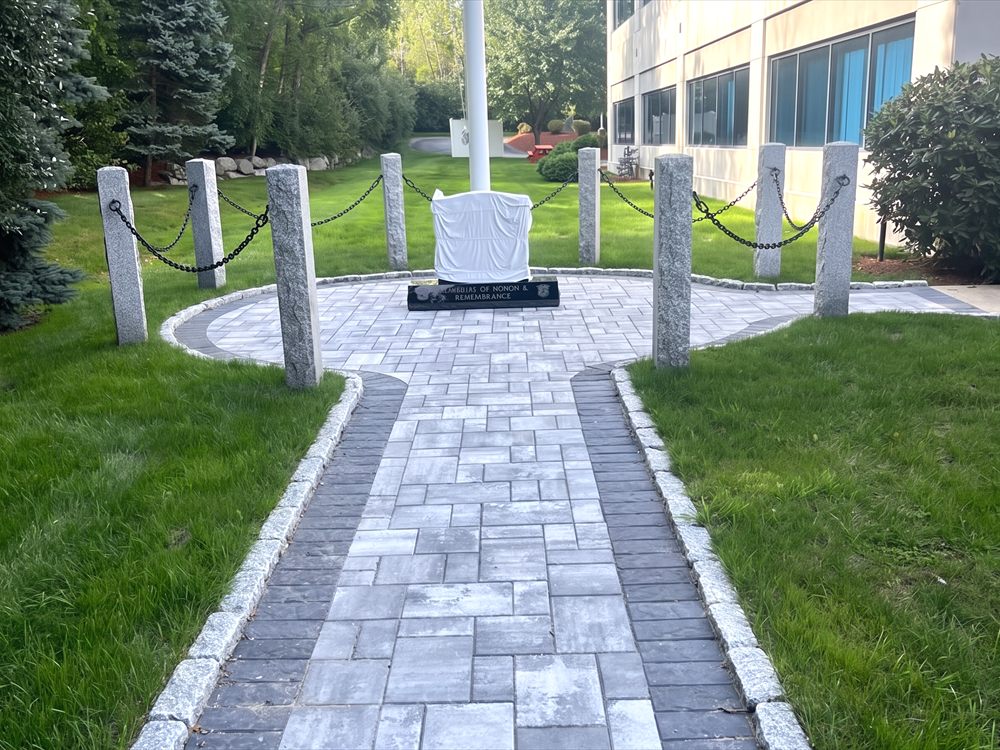 Paver walkway with a contrasting border running through a lawn